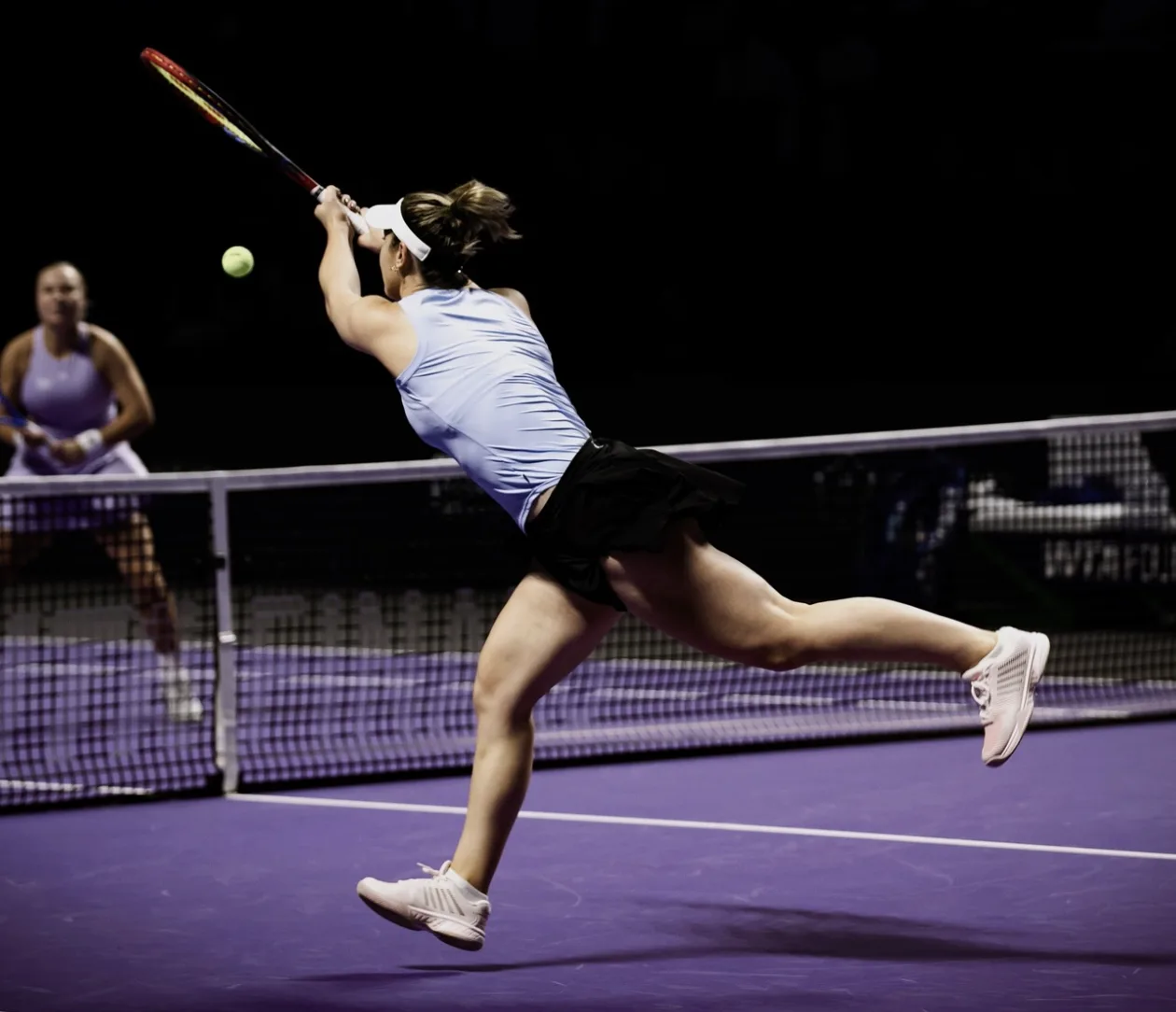 Gaby Dabrowski stretching for a volley at the net